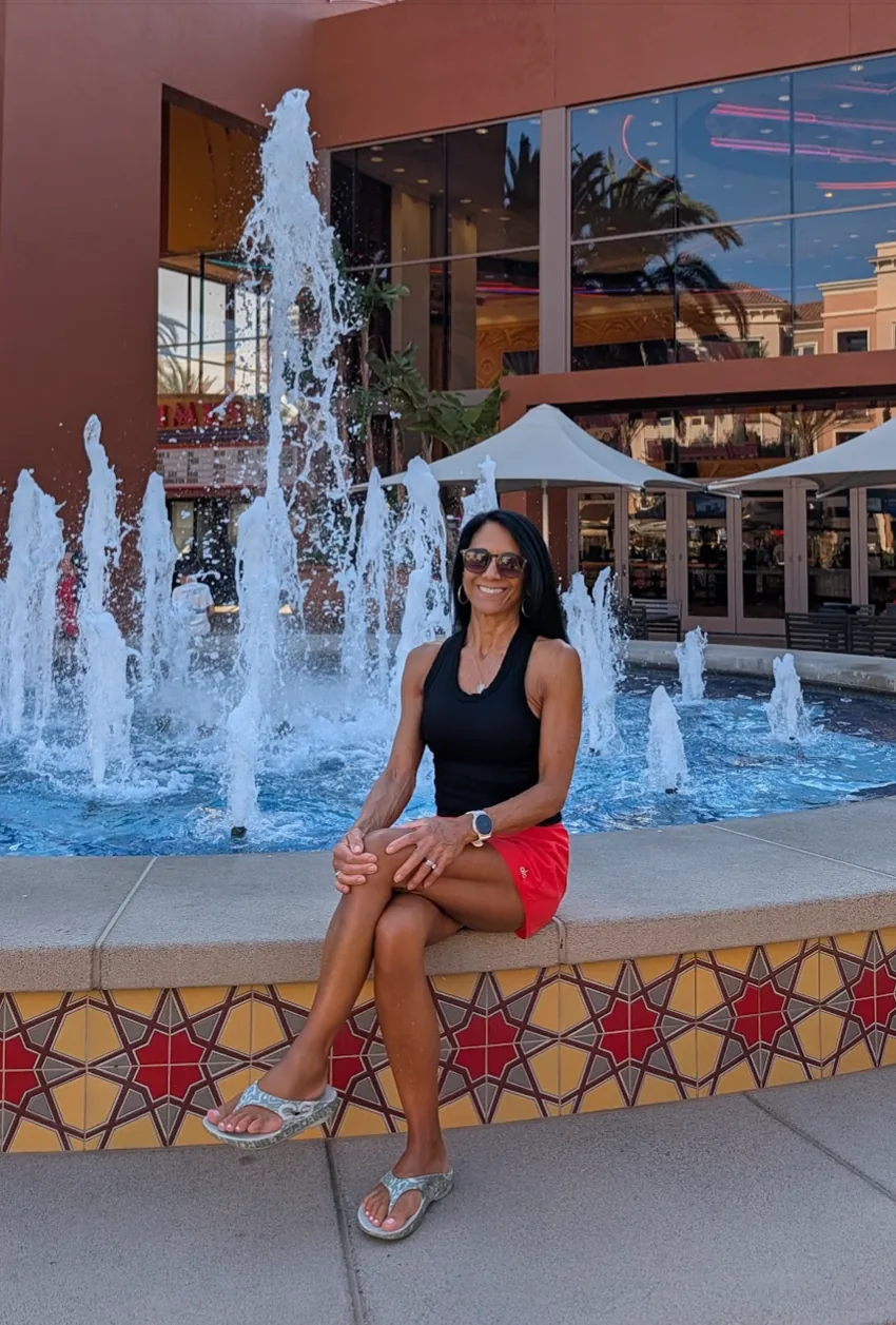 Suzette seated beside a fountain
